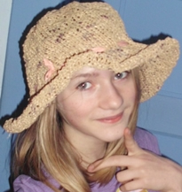beach hat knit from tan plastic bags, to resemble a straw hat