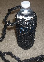 black water bottle carrier, knit from recycled VHS video tape