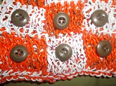 orange and white checkerboard knit from recycled plastic bags, with buttons as checkers