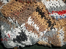 multicolored entrelac pattern knit out of various colors of plastic bags