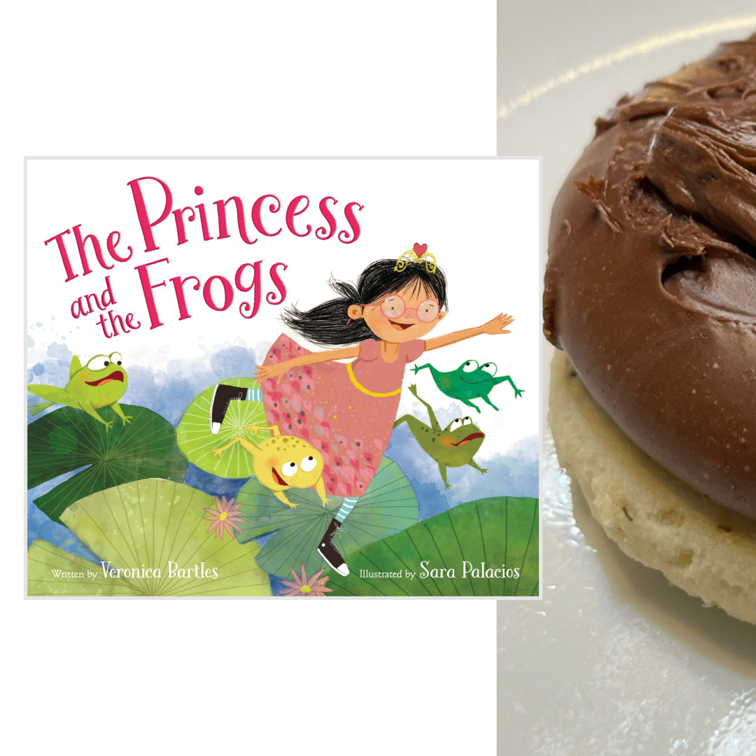 sugar cookie topped with a thick layer of fudge, with the cover of THE PRINCESS AND THE FROGS by Veronica Bartles and Sara Palacios on the left side - 