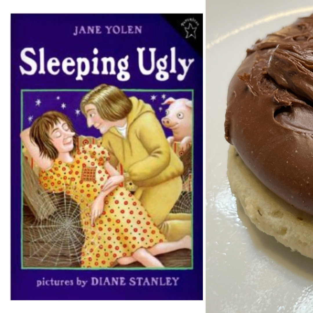 sugar cookie topped with a thick layer of fudge, with the cover of SLEEPING UGLY by Jane Yolen and Diane Stanley on the left side - 