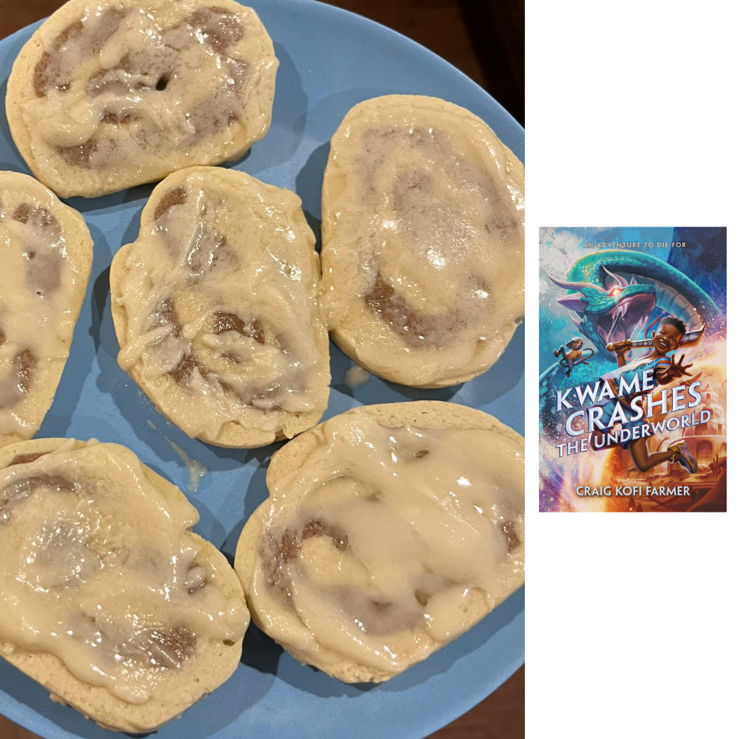 frosted cinnamon roll cookies on a blue plate with the cover of KWAME CRASHES THE UNDERWORLD by Craig Kofi Farmer on the left of the photo