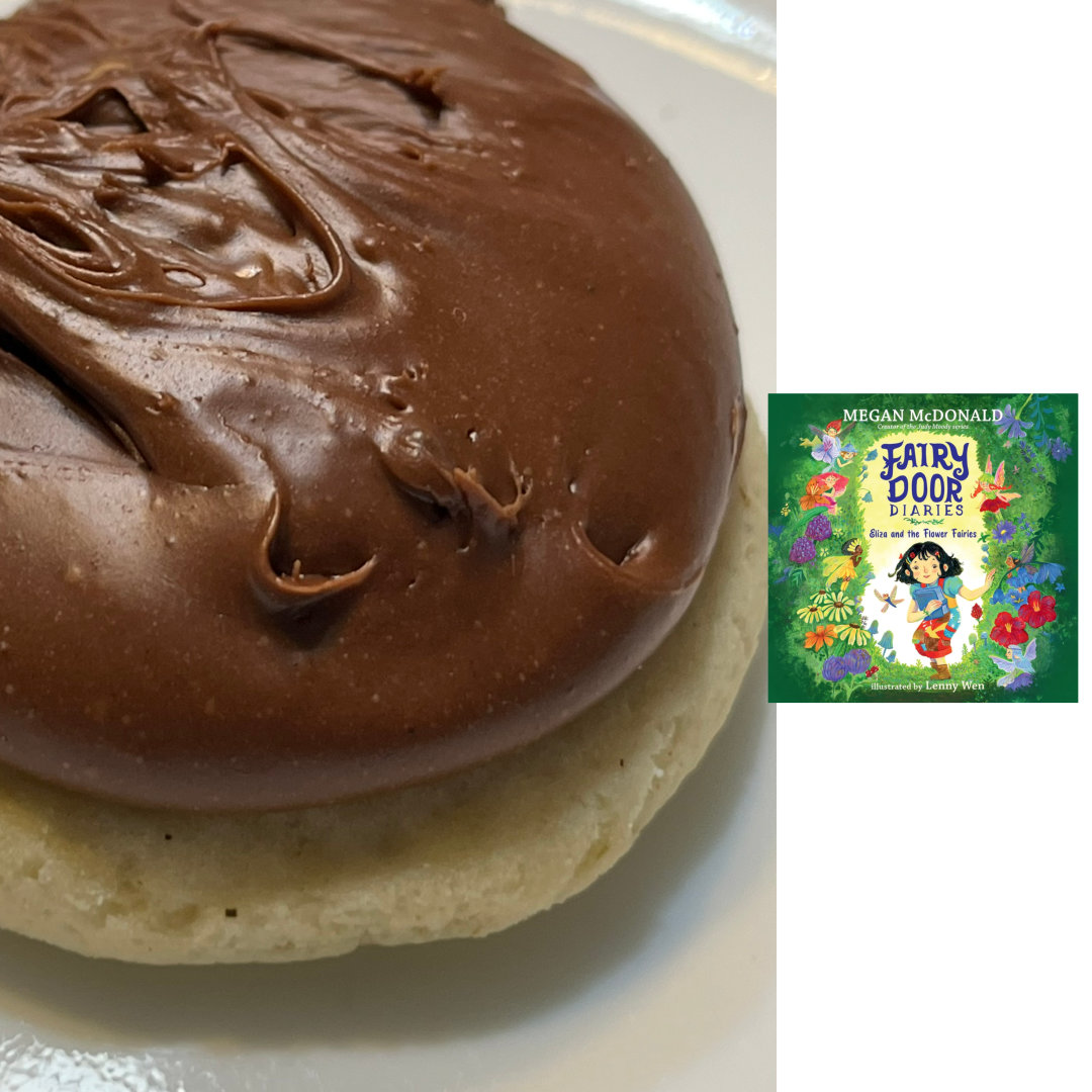 lavender chamomile sugar cookie topped with a thick layer of fudge, with the cover of FAIRY DOOR DIARIES: ELIZA AND THE FLOWER FAIRIES by Megan McDonald and Lenny Wen against a white background on the right of the cookies