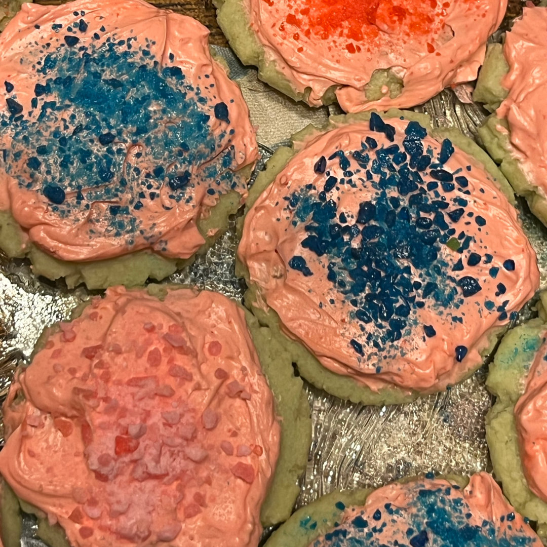 lime sugar cookies with strawberry frosting, topped with strawberry, cotton candy, and blue raspberry Pop Rocks candies