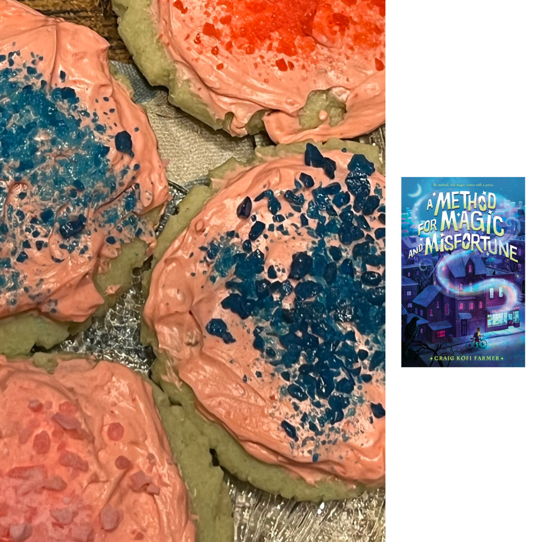 lime sugar cookies with strawberry frosting, topped with strawberry, cotton candy, and blue raspberry Pop Rocks candies, with the cover of A METHOD OF MAGIC AND MISFORTUNE by Craig Kofi Farmer against a white background on the right of the cookies
