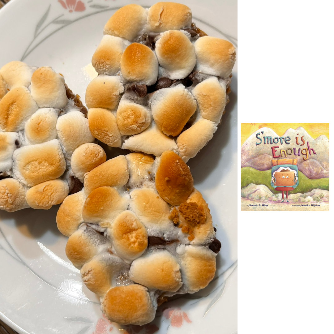 Cropped photo of 3 S'mores Cookies on a white plate with a green and pink floral border. Each cookie has a molasses and honey sugar cookie crust, filled with dark chocolate and topped with approximately 12 perfectly-golden toasted mini marshmallows. To the right of the cookie photo, against a white background is the cover of S'MORE IS ENOUGH by Brenda S. Miles and Monika Filipina. An illustrated, anthropomorphized s'more wearing red pants and a hiking backpack stands in front of a mountain landscape, ready for adventure. The title is written in colorful, playful block letters above his head.